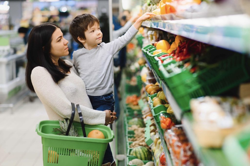 Mother at grocery store with her child.